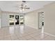 Bright living room with tile floors and a large window offering a view of the front yard at 1610 Brady Dr, Deltona, FL 32725