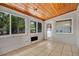Bright sun room featuring tile flooring, wood paneled ceiling, and multiple windows at 1610 Brady Dr, Deltona, FL 32725