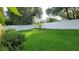 A well-maintained backyard featuring lush green grass and a white vinyl fence at 1632 Blue Grass Blvd, Deland, FL 32724