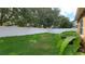 Spacious backyard with green grass, surrounded by a white privacy fence and mature trees at 1632 Blue Grass Blvd, Deland, FL 32724