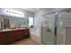 Bright bathroom features a soaking tub, a glass enclosed shower, and dual sinks at 1632 Blue Grass Blvd, Deland, FL 32724