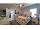 A carpeted bedroom with a ceiling fan and a white bed frame at 1632 Blue Grass Blvd, Deland, FL 32724