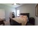 A carpeted bedroom with a ceiling fan and a dark-wood bed frame at 1632 Blue Grass Blvd, Deland, FL 32724