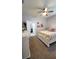 A carpeted bedroom with a ceiling fan and a white bed frame at 1632 Blue Grass Blvd, Deland, FL 32724