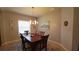 Warm and inviting dining room with modern light fixture, wood table, and an area rug at 1632 Blue Grass Blvd, Deland, FL 32724
