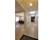 Open-concept hallway featuring neutral paint, decorative lighting, and seamless flow to the dining area and living spaces at 1632 Blue Grass Blvd, Deland, FL 32724