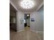 Bright hallway with modern lighting connects to the kitchen and other living areas at 1632 Blue Grass Blvd, Deland, FL 32724