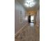 Well-lit hallway showcasing the entrance, complemented by decorative artwork and a stylish area rug at 1632 Blue Grass Blvd, Deland, FL 32724