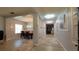 Light-filled hallway with decorative lighting leads to dining area with wood table, kitchen and living spaces at 1632 Blue Grass Blvd, Deland, FL 32724