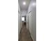 Hallway view of a bedroom with neutral carpet and white closet doors at 1632 Blue Grass Blvd, Deland, FL 32724