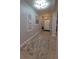 Well-lit hallway with decorative artwork leads to the front entrance, complemented by a stylish area rug at 1632 Blue Grass Blvd, Deland, FL 32724