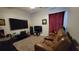 Cozy living room with a comfortable brown leather sofa and carpeted floor at 1632 Blue Grass Blvd, Deland, FL 32724