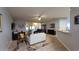 Spacious living room boasts hardwood flooring, a ceiling fan, and natural light, perfect for relaxation and entertainment at 1632 Blue Grass Blvd, Deland, FL 32724