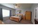 Bright main bedroom featuring a ceiling fan and a large window at 1632 Blue Grass Blvd, Deland, FL 32724