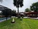 Backyard featuring an in-ground pool, pergola with a hot tub, and seating area at 180 Pine Grove Ct, Daytona Beach, FL 32119