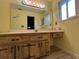Bright bathroom featuring a large mirror, wooden vanity, and ample counter space at 180 Pine Grove Ct, Daytona Beach, FL 32119