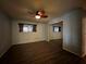 Cozy bedroom featuring wood floors, a modern ceiling fan, and a mirrored closet at 180 Pine Grove Ct, Daytona Beach, FL 32119