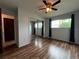 Bedroom with hardwood floors, closet with mirrored doors, and ceiling fan at 180 Pine Grove Ct, Daytona Beach, FL 32119