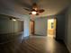 Spacious bedroom with hardwood floors and a mirrored closet, leading to the ensuite bathroom at 180 Pine Grove Ct, Daytona Beach, FL 32119