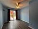 Sunny bedroom with wood floors and sliding glass doors leading to the backyard at 180 Pine Grove Ct, Daytona Beach, FL 32119