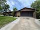 Ranch-style house with brick exterior, screened garage and well-maintained lawn at 180 Pine Grove Ct, Daytona Beach, FL 32119