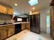 Kitchen features light-colored wood cabinets, marble countertops, a skylight, and stainless steel appliances at 180 Pine Grove Ct, Daytona Beach, FL 32119