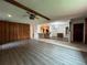 Spacious living room features wood-look flooring, wood-paneled wall, and an open floorplan to the kitchen at 180 Pine Grove Ct, Daytona Beach, FL 32119