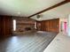 Charming living room with brick fireplace and wood-paneled walls that is perfect for relaxation at 180 Pine Grove Ct, Daytona Beach, FL 32119