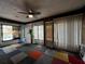 Bright living room with a view of the pool and access to the backyard at 180 Pine Grove Ct, Daytona Beach, FL 32119