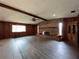 Living room with beautiful brick fireplace, wood-look flooring, and exposed ceiling beams at 180 Pine Grove Ct, Daytona Beach, FL 32119
