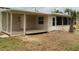 Back porch with wood flooring and large screened windows overlooking the backyard at 1821 Talmadge St, Deland, FL 32724