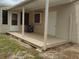A covered back porch with outdoor access door at 1821 Talmadge St, Deland, FL 32724