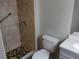 Tiled walk-in shower and toilet at 1821 Talmadge St, Deland, FL 32724