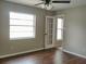 Bright bedroom features wood floors, ceiling fan, and glass panel door at 1821 Talmadge St, Deland, FL 32724