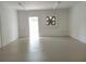 Clean, bright garage space ready for your vehicles and projects featuring clean white walls and door to outdoors at 1821 Talmadge St, Deland, FL 32724