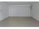 Spacious garage area with a roll-up door, ready to house your vehicles or serve as a workshop at 1821 Talmadge St, Deland, FL 32724
