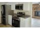 Modern kitchen boasting stainless steel appliances, white cabinets, and granite countertops at 1821 Talmadge St, Deland, FL 32724
