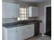 Bright kitchen featuring granite countertops, white cabinets, and stainless steel appliances at 1821 Talmadge St, Deland, FL 32724