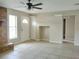Inviting living room with tile floors, a ceiling fan, and a cozy brick fireplace at 1821 Talmadge St, Deland, FL 32724