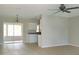 Spacious living room featuring neutral tile flooring and sliding doors to a screened patio at 1821 Talmadge St, Deland, FL 32724