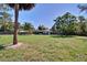 Sprawling backyard with lush lawn and mature trees, perfect for outdoor entertaining at 1828 West Pkwy, Deland, FL 32724