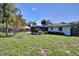 Expansive backyard with a fire pit, perfect for outdoor gatherings, and a glimpse of the home's screened patio at 1828 West Pkwy, Deland, FL 32724