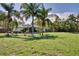 A white home with a spacious, green backyard and privacy fence perfect for Gathering and entertaining at 1828 West Pkwy, Deland, FL 32724