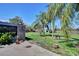Spacious backyard featuring mature palm trees and a patio area, great for entertaining at 1828 West Pkwy, Deland, FL 32724