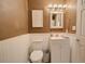 Cozy half-bathroom with beadboard paneling, modern white vanity, and stylish lighting at 1828 West Pkwy, Deland, FL 32724