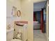 Cozy bathroom featuring modern fixtures, a charming mirror, and stylish red mosaic backsplash at 1828 West Pkwy, Deland, FL 32724