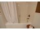 Clean bathtub with white tile surround, a shower curtain, and a convenient toiletry shelf at 1828 West Pkwy, Deland, FL 32724