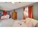 Cozy bedroom with a comfortable seating area, plush bedding, and warm, inviting decor at 1828 West Pkwy, Deland, FL 32724