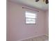 Bright bedroom featuring a window with black trim, neutral walls, and stylish flooring at 1828 West Pkwy, Deland, FL 32724