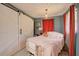 Charming bedroom with a sliding barn door, plush bedding, and warm accents at 1828 West Pkwy, Deland, FL 32724